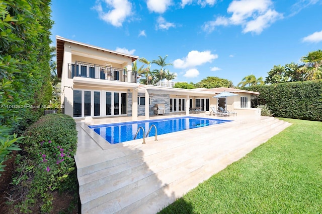 1500 NE 103rd St, Miami Shores, FL 33138 - back of house featuring a balcony, french doors, a patio, stucco siding, and a yard