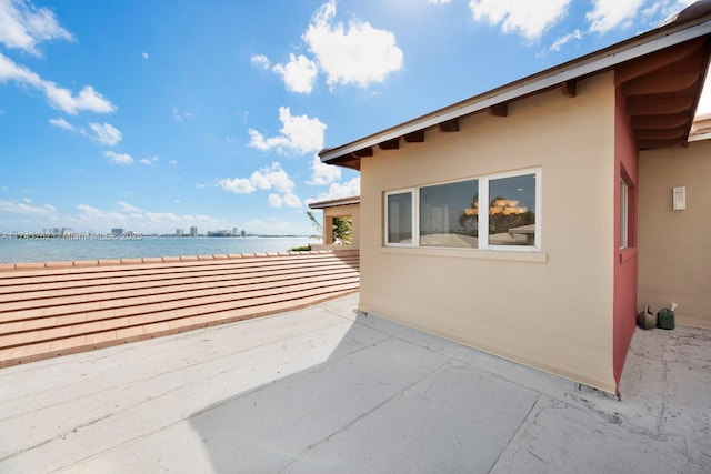 view of patio with a water view