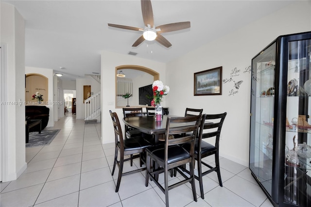 tiled dining space featuring ceiling fan