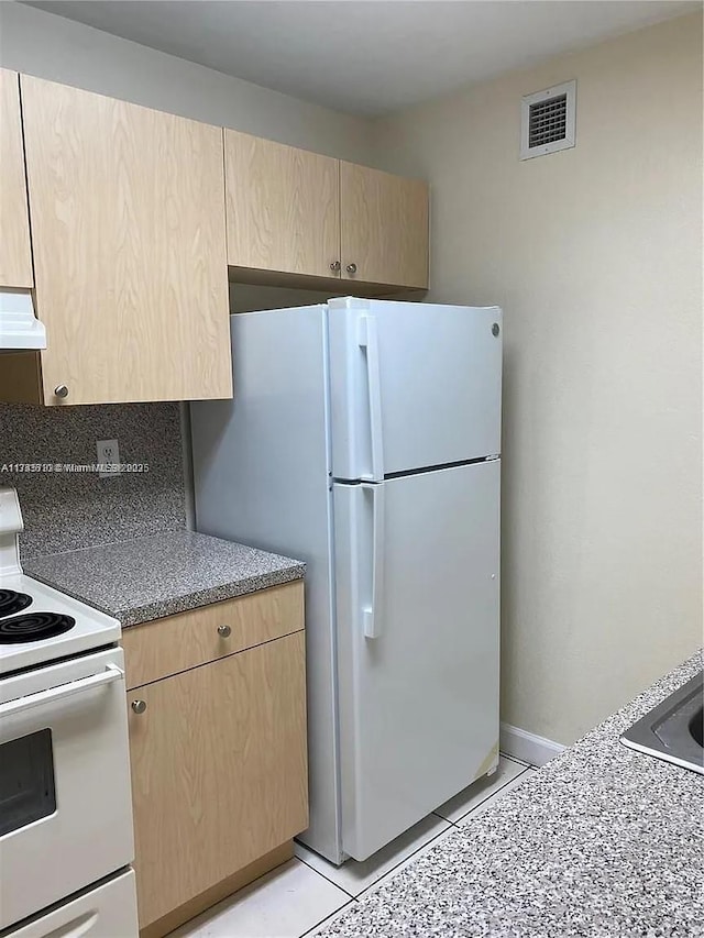 kitchen featuring tasteful backsplash, light tile patterned flooring, light brown cabinetry, and white appliances