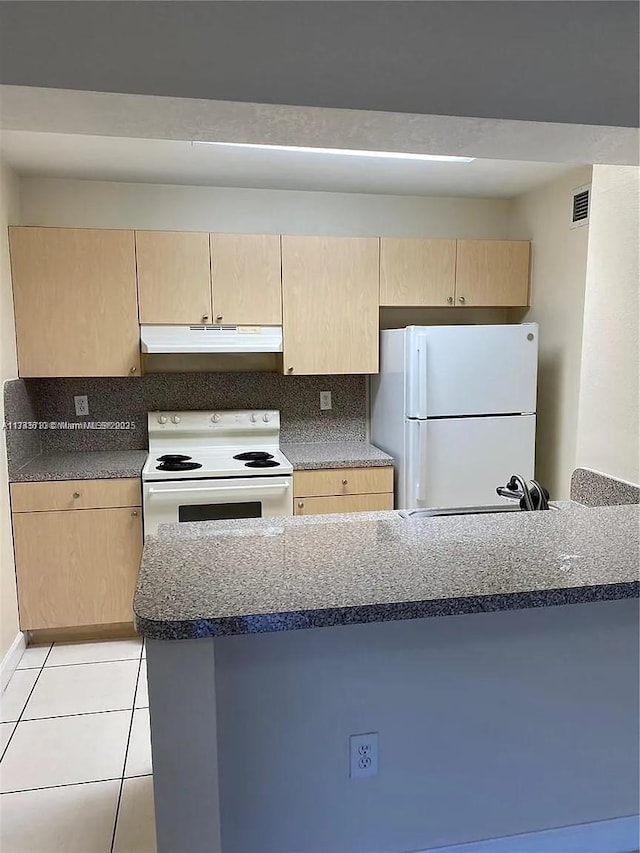 kitchen featuring light tile patterned floors, white appliances, and light brown cabinets