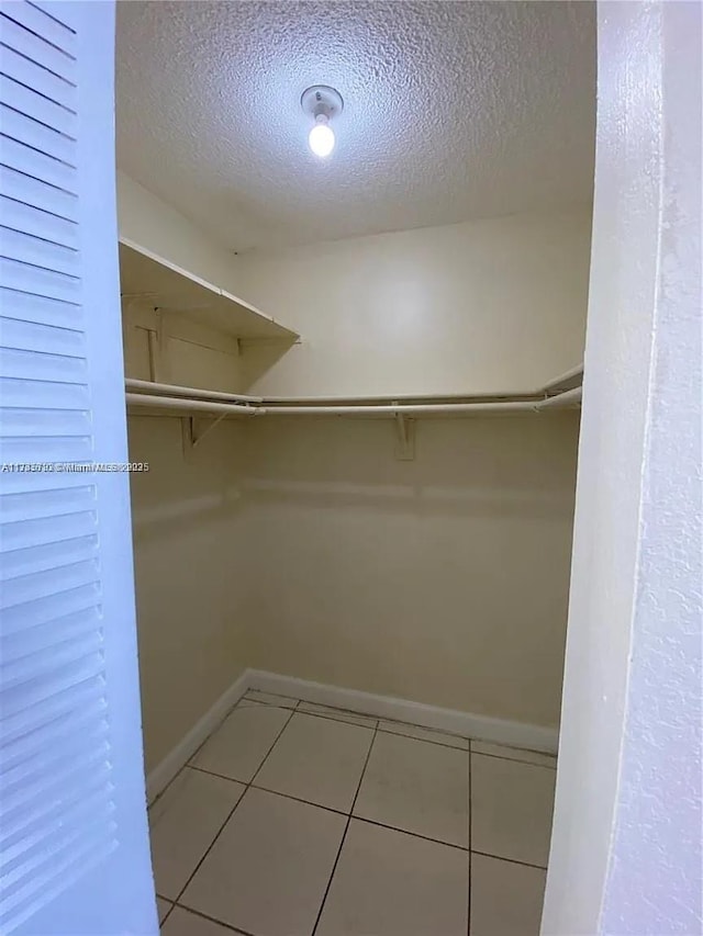 spacious closet with tile patterned floors