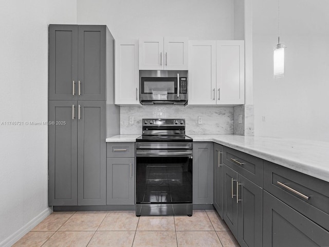 kitchen featuring white cabinetry, light tile patterned floors, tasteful backsplash, and range with electric cooktop