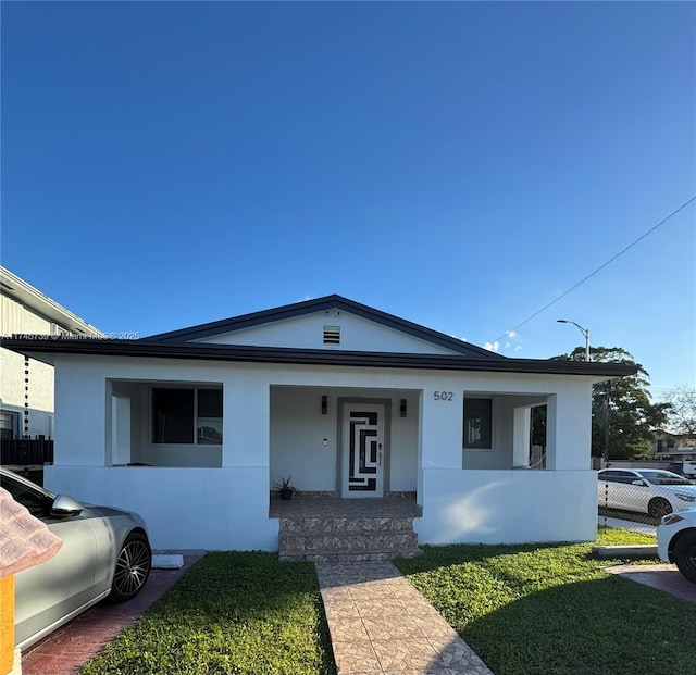 view of front facade with a porch and a front yard