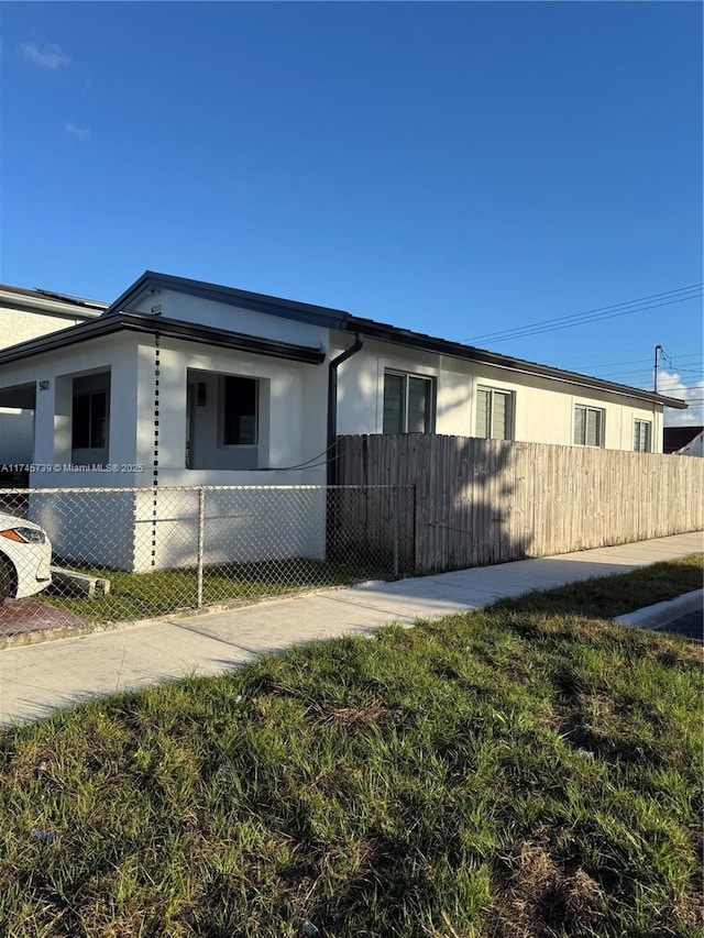 view of property exterior with a yard