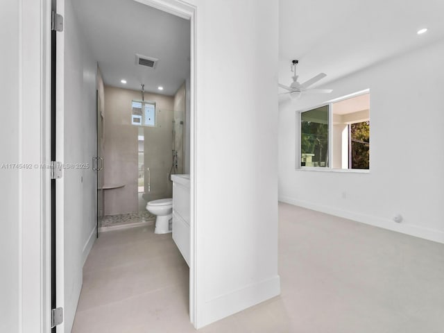 bathroom with a wealth of natural light, an enclosed shower, ceiling fan, and toilet