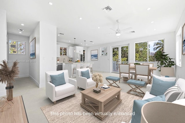 living area featuring french doors, visible vents, baseboards, recessed lighting, and a ceiling fan