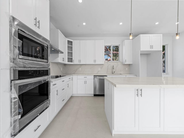 kitchen with hanging light fixtures, white cabinetry, backsplash, appliances with stainless steel finishes, and recessed lighting
