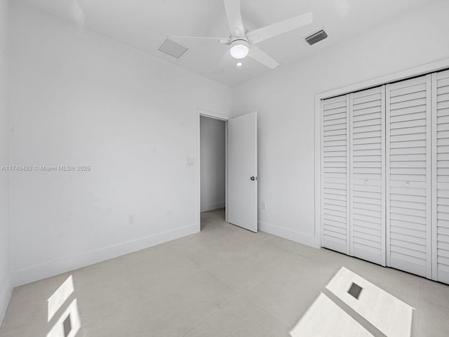 unfurnished bedroom featuring baseboards, visible vents, a closet, and ceiling fan
