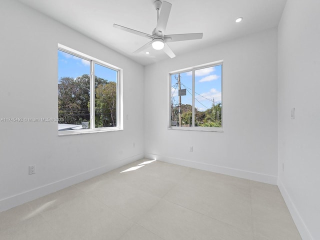 spare room featuring light tile patterned floors, baseboards, a ceiling fan, and recessed lighting