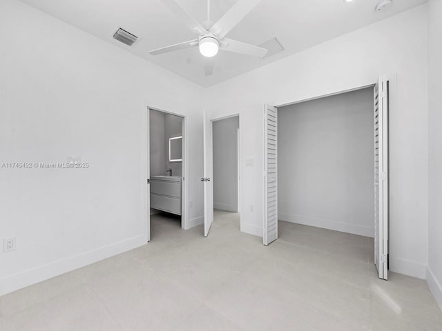 unfurnished bedroom featuring ceiling fan, baseboards, visible vents, and a closet