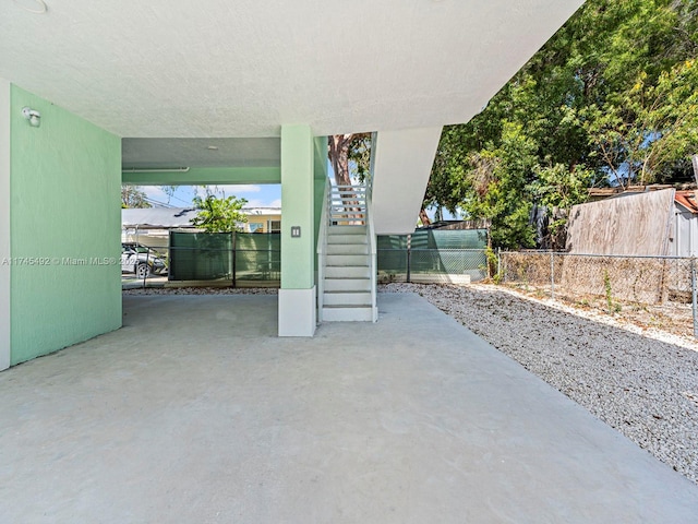 view of patio / terrace with stairway and fence