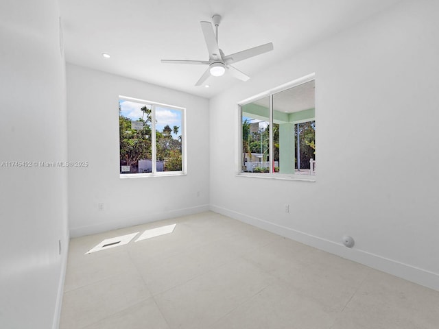 spare room featuring baseboards, a ceiling fan, tile patterned floors, and recessed lighting