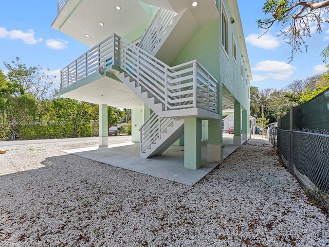 exterior space featuring fence and stairs