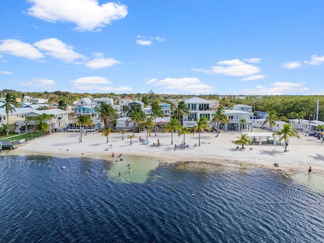 drone / aerial view featuring a beach view and a water view