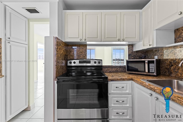 kitchen featuring white cabinetry, appliances with stainless steel finishes, sink, and backsplash