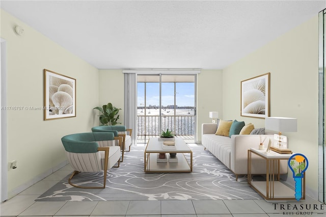 living room with a wall of windows, tile patterned floors, and a textured ceiling