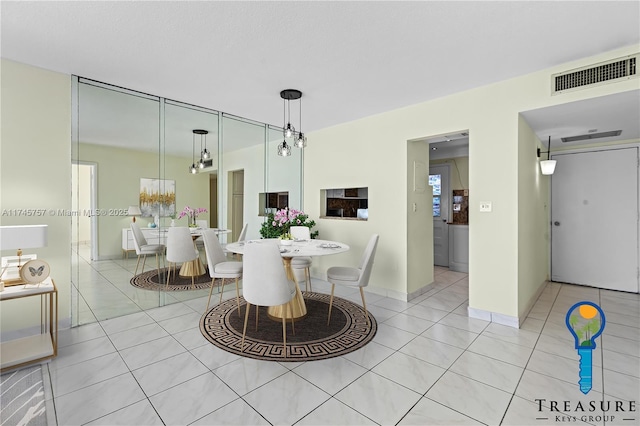 dining space featuring light tile patterned flooring