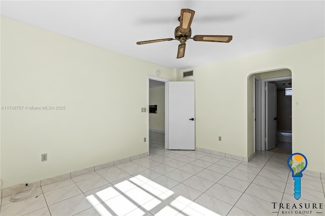 empty room with light tile patterned flooring and ceiling fan