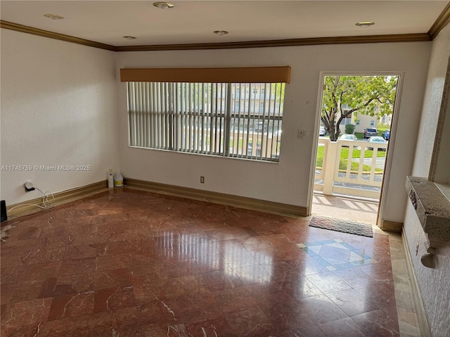 unfurnished room with crown molding