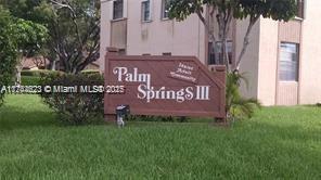 community / neighborhood sign with a yard