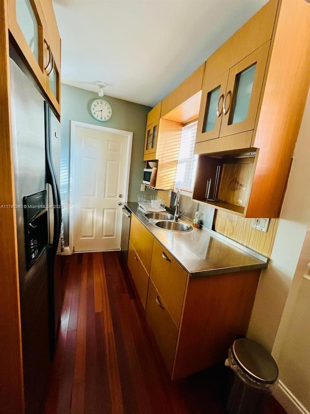 kitchen with sink, dark wood-type flooring, and stainless steel appliances