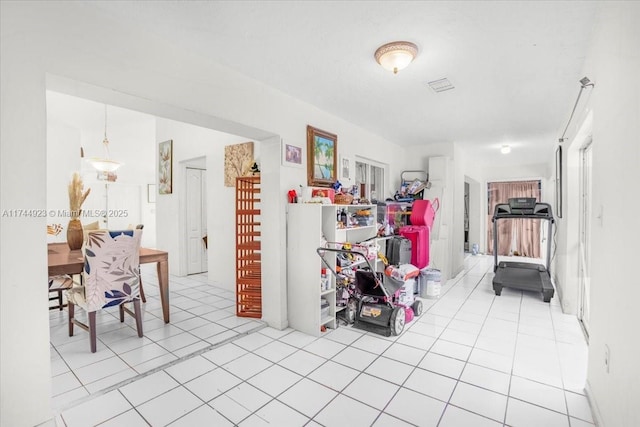 hall featuring light tile patterned flooring