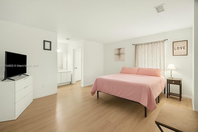 bedroom featuring visible vents, baseboards, and light wood-style floors