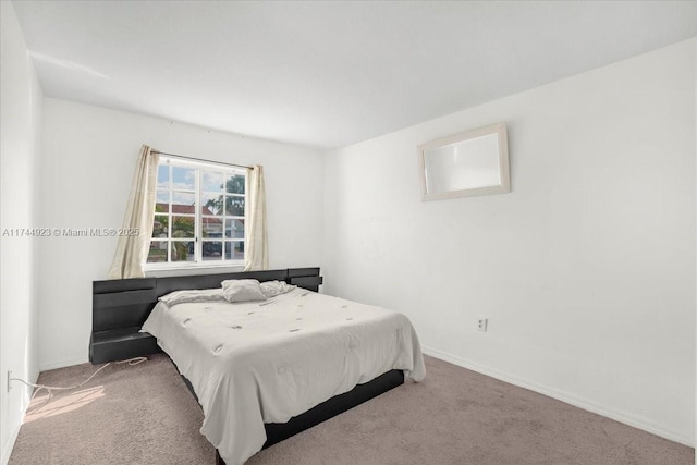 carpeted bedroom with baseboards