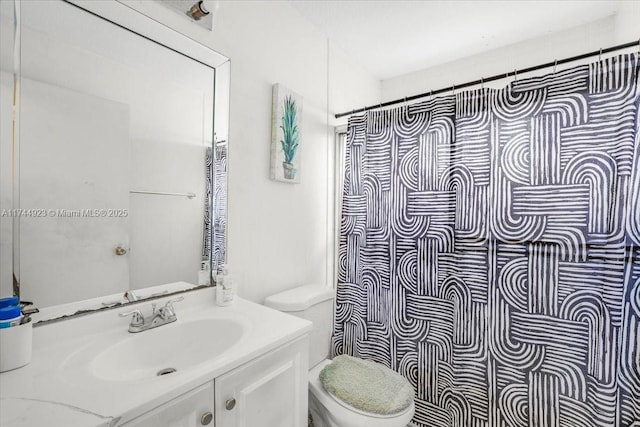 bathroom with vanity, toilet, and curtained shower