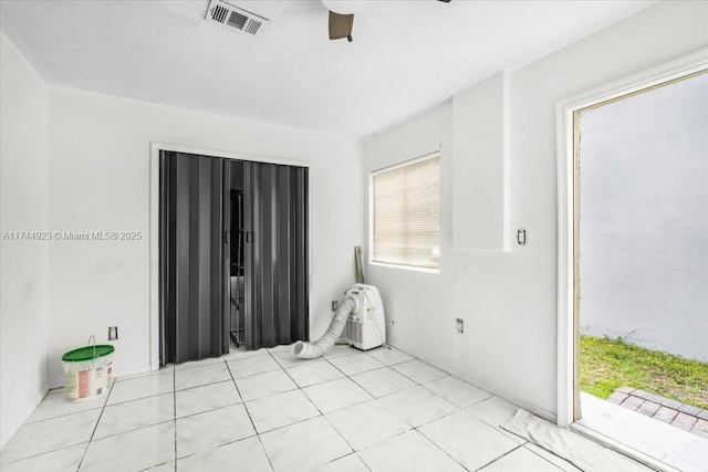 unfurnished room with a ceiling fan and visible vents