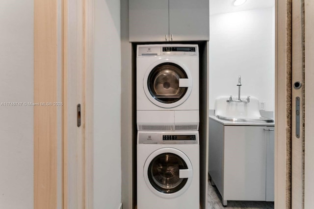 laundry room with stacked washer / dryer