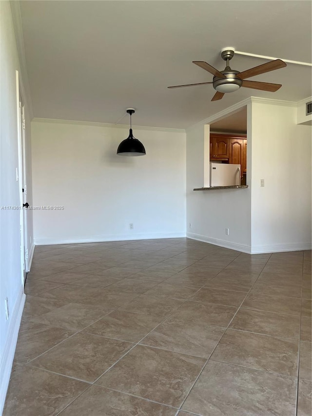 empty room featuring ornamental molding and ceiling fan