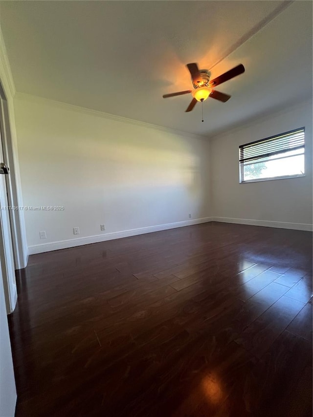 unfurnished room with crown molding, dark wood-type flooring, and ceiling fan