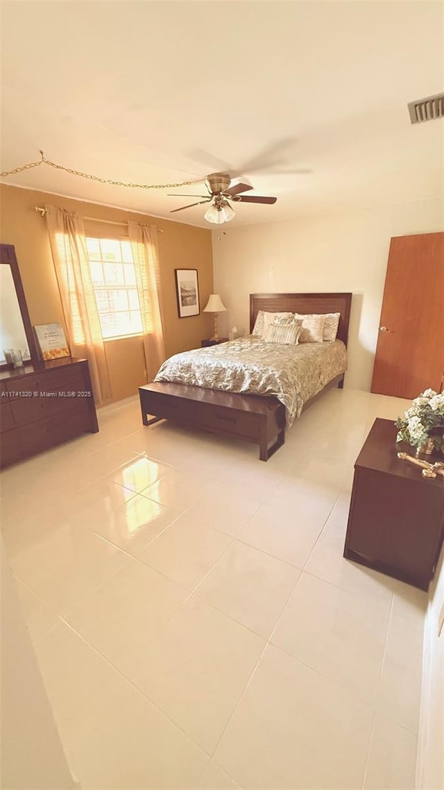 tiled bedroom with ceiling fan