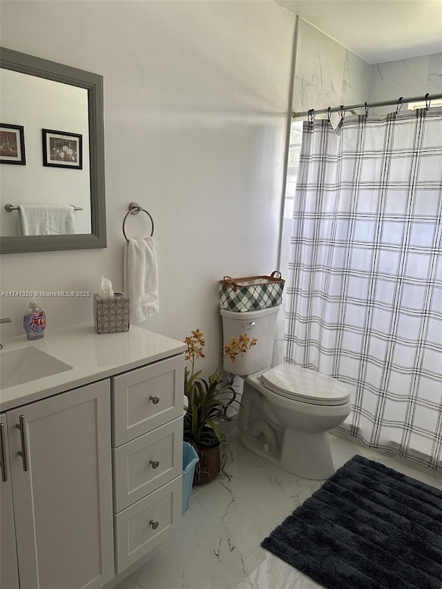 bathroom featuring vanity, curtained shower, and toilet