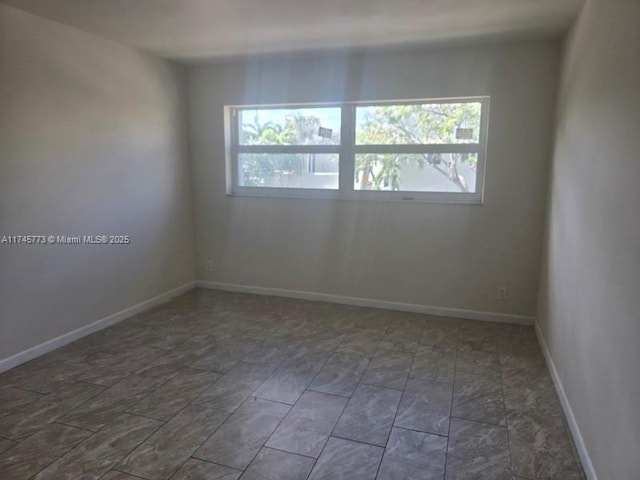 unfurnished room featuring plenty of natural light