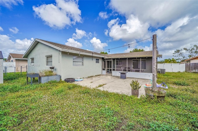 2440 SW 12th St, Deerfield Beach, FL 33442 - rear view of house with cooling unit, a sunroom, a patio area, and a lawn
