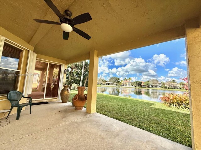 view of patio / terrace with a water view and ceiling fan
