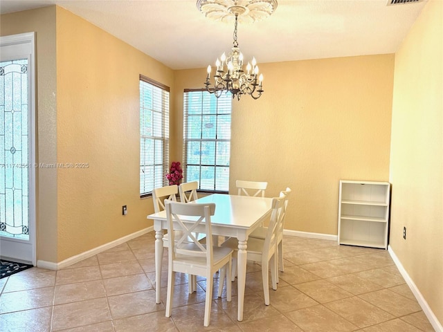 4602 SW 131st Ter, Miramar, FL 33027 - dining area with a chandelier, light tile patterned floors, a textured wall, and baseboards