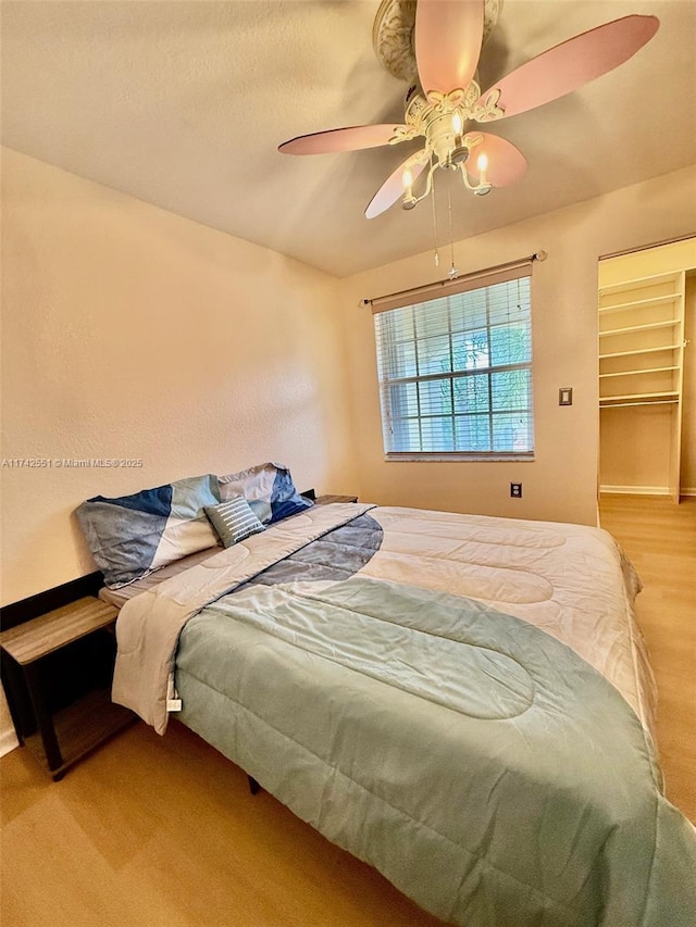 4602 SW 131st Ter, Miramar, FL 33027 - bedroom featuring light wood-style floors, a ceiling fan, baseboards, and a walk in closet