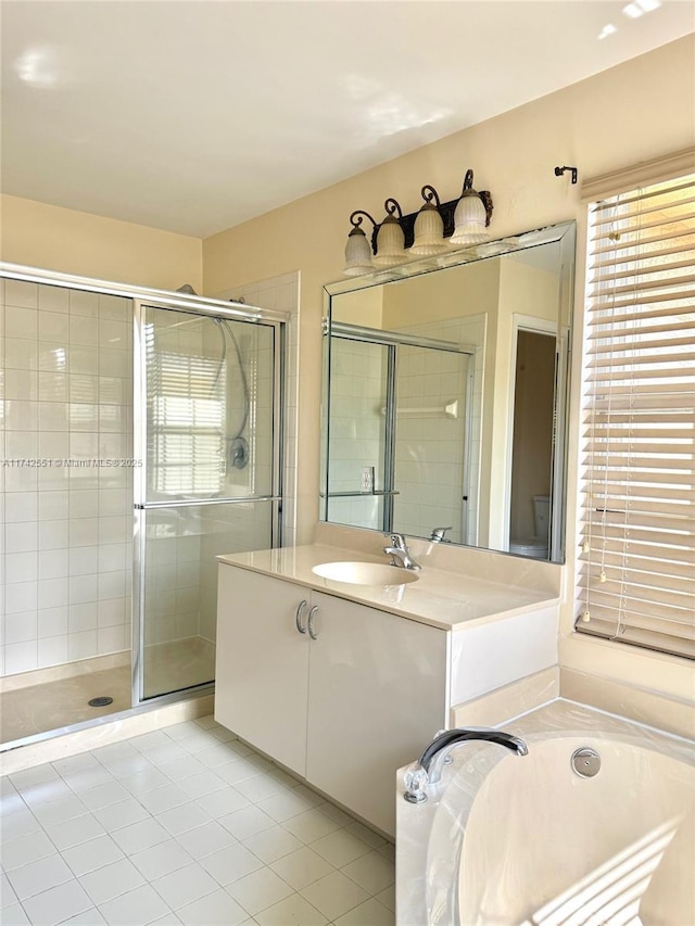 full bath with vanity, tile patterned floors, a shower stall, and a garden tub