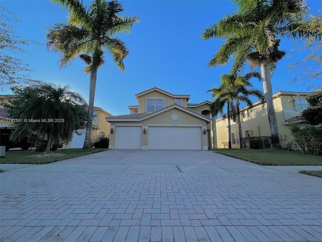 4602 SW 131st Ter, Miramar, FL 33027 - view of front of property featuring decorative driveway, stucco siding, a garage, and a front lawn