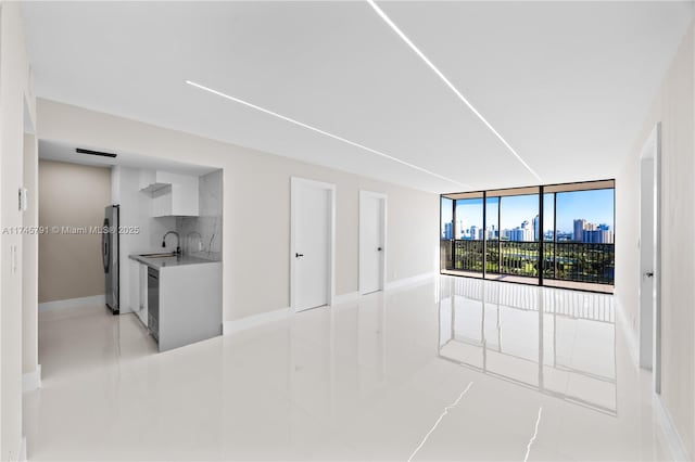 empty room with expansive windows and sink