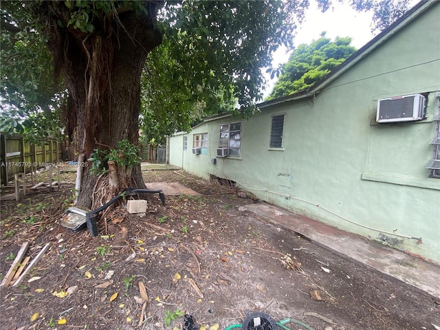 view of yard with an AC wall unit