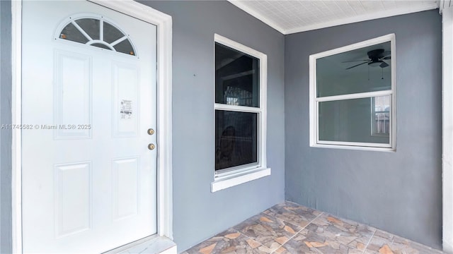 entrance to property with ceiling fan