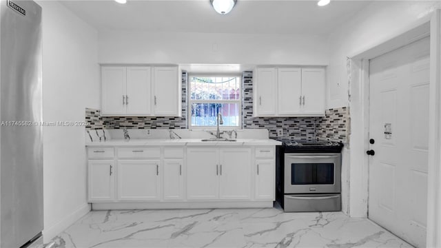 kitchen with white cabinetry, sink, backsplash, and appliances with stainless steel finishes