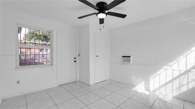 tiled empty room featuring ceiling fan