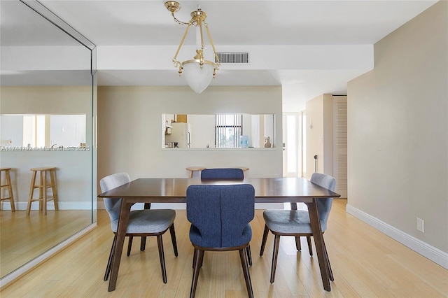 dining area featuring light wood-type flooring