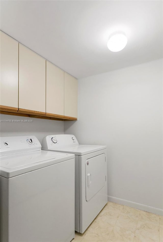 laundry room featuring cabinets and washer and dryer